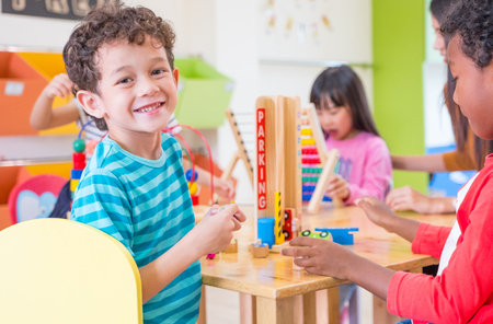 Kindergarten students smile when playing toy in playroom at preschool international,education concept.の写真素材