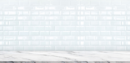 Empty white marble table top with white ceramic tile wall background,Mock up banner ads for display or montage of product or your design ,Luxury modern theme.の写真素材