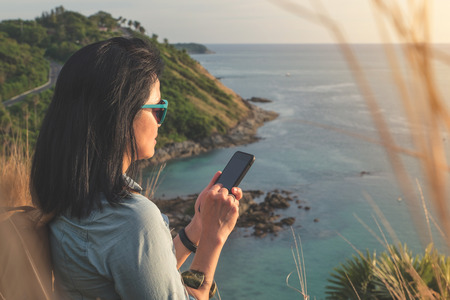 Young traveler woman use mobile phone taking of photo at beautiful of nature at top of mountain and...
