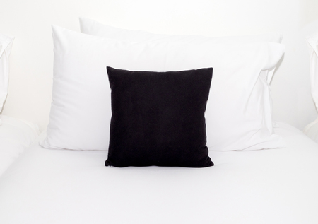 Close up three pillows and bed sheets on in bedroomの写真素材