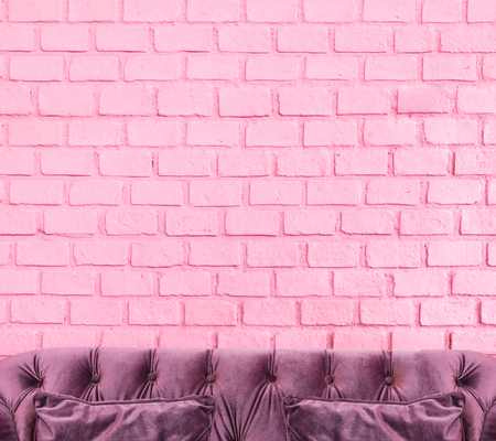 Purple luxury sofa at pastel pink painting on brick wall,Leave space for adding your design or use as background for advertise your product.の写真素材
