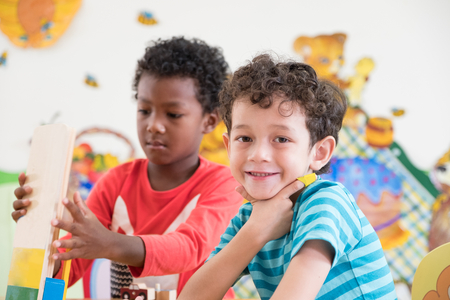 Kindergarten students smile when playing toy in playroom at preschool international,education conceptの写真素材