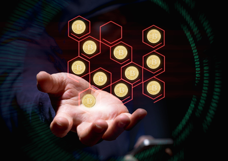 Hooded cyber crime hacker using mobile phone hacking blockchain of bitcoins in  cyberspace.stealing...