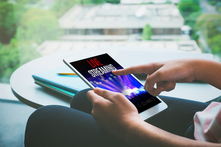 Close up hand of woman sitting watch live streaming concert on tablet at home,Digital marketing...