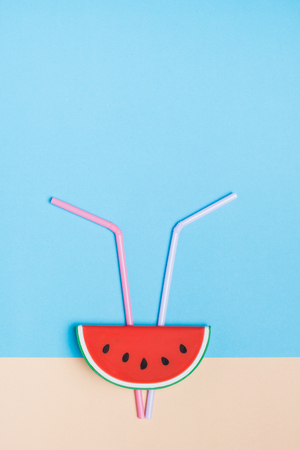 Set of summer watermelon with straw on pastel beige and blue background vertical.Holiday vacation backdrop.Copy space for display of product or content designの写真素材