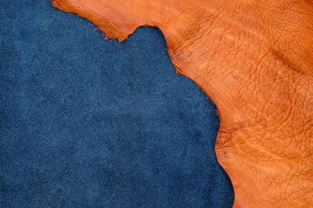 Close up orange rough edge and navy blue leather divide in two section, fashion texture background,fabric division.の写真素材
