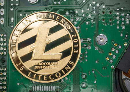 Gold metallic litecoin on electronic circuit motherboard.crypto currency mining.Digital money on blockchain networkの写真素材