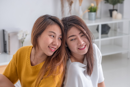 Asia lesbian lgbt couple hug and sitting on bed near white window sunlight with happiness moment together,love wins conceptの写真素材