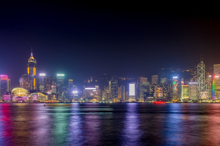 Hong Kong skyline view from kowloon side,colorful night life,cityscape and reflection on water.の写真素材