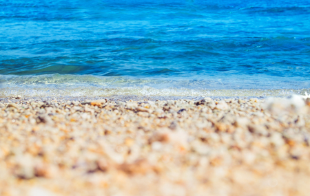 Close up wave of blue sea on sand beach seashore,nature background,summer time,selective focus on wave.の写真素材