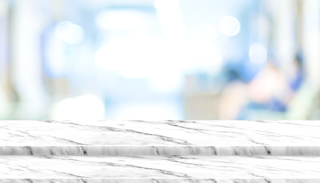 Empty step white marble table top with blur patient waiting for doctor at hospital with bokeh light at background,Mock up template for display of your design,Banner for advertise of productの写真素材