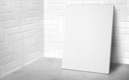 Blank poster at corner studio room with white tile wall and concrete floor background,Mock up studio room for display or montage of product for advertising on media,Business presentationの写真素材