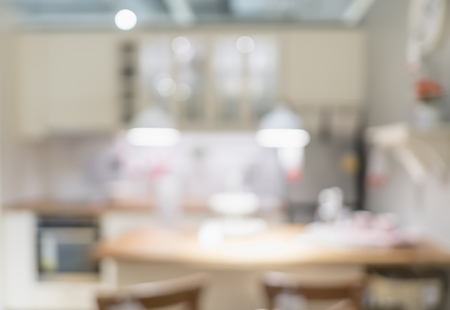 Blurred background modern kitchen and dinning room in house with bokeh light.lifestyle backdropの写真素材