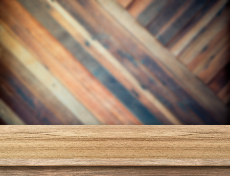 modern wooden table top at blurred diagonal wood plank wall,Template mock up for display or montage of productの写真素材