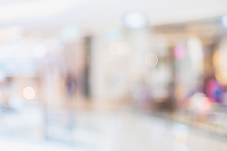 Blurred background of people shopping at department store mall with bokeh lightsの写真素材