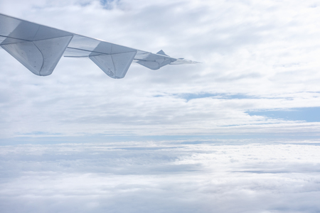 airplane wings when flying with cloudy sky.transportation and travel conceptの写真素材