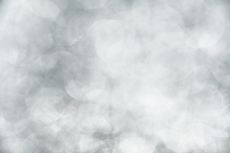 Blurred silver bokeh abstract background.use as backdrop for holiday or anniversary occasion celebrationの写真素材