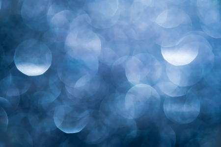 Blurred dark blue bokeh abstract background.use as backdrop for holiday or anniversary occasion celebrationの写真素材