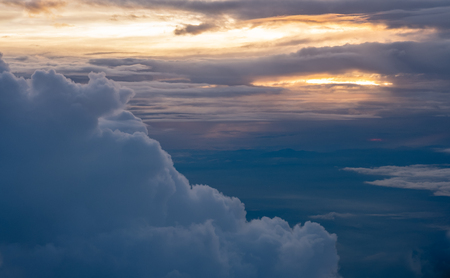 Aerial view of sunset with big cloud at evening sky view on airplane transportation.travel lifestyle.hope conceptの写真素材