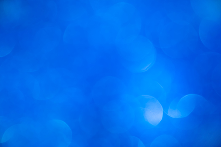 Blurred vivid blue bokeh abstract background.use as backdrop for holiday or anniversary occasion celebrationの写真素材