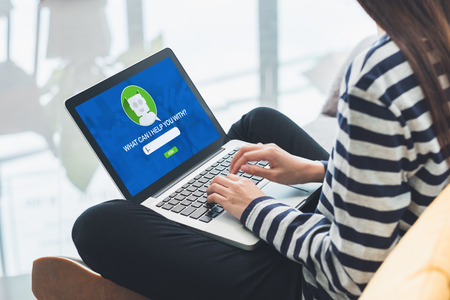 Asia woman ask chat bot function in app on laptop screen looking for customer support online shopping shop with apps,digital marketing concept,artificial intelligence (ai) systemの写真素材