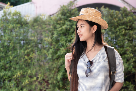 Asian woman traveler backpacker looking for route of place on street in when travel in city,journey tripの写真素材