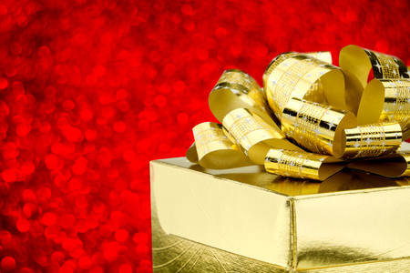 Close up Golden present box with big bow at bokeh white blur background, Leave space on top to adding your contentà¹の写真素材