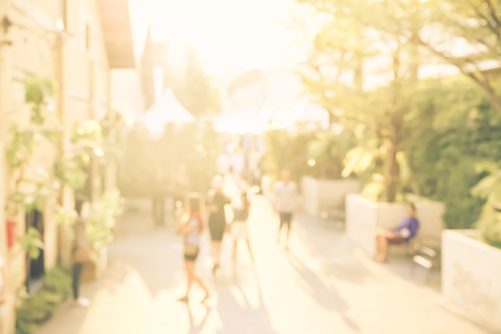 Blurred background people shopping at market fair in sunny day, blur background with bokehの写真素材