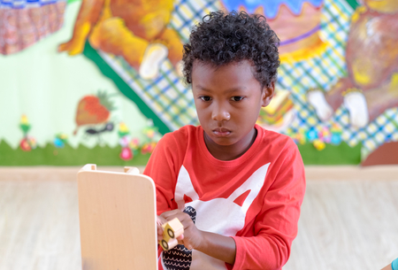 Black American kid play car toy at classroom in kindergarten preschool,Education conceptの写真素材