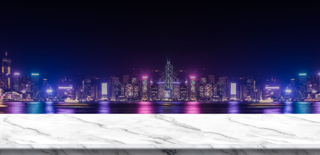 Empty white marble balcony at blur cityscape view building at night,Mock up template for display of product,Business presentationの写真素材