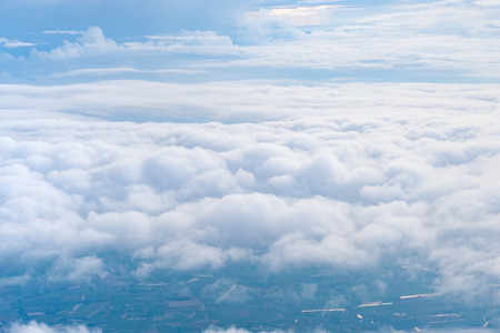 Big Blue sky and Cloud and city under cloud Top view from airplane window,Nature backgroundの写真素材