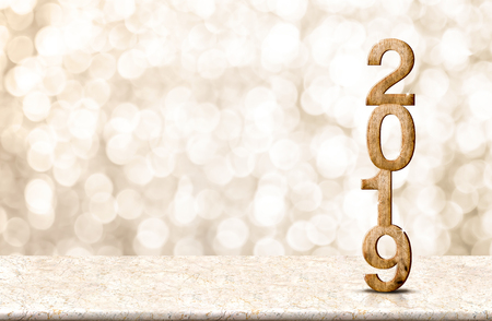 Happy New Year 2019 wood with sparkling star on marble table with gold bokeh background,Holiday festive celebration concept.copy space for display of text or contentの写真素材