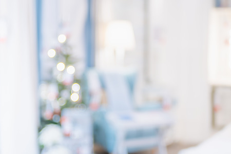Christmas tree with light string and ball decoration with abstract blur living room bokeh light background at home,Backdrop for winter festive holiday celebration conceptの写真素材