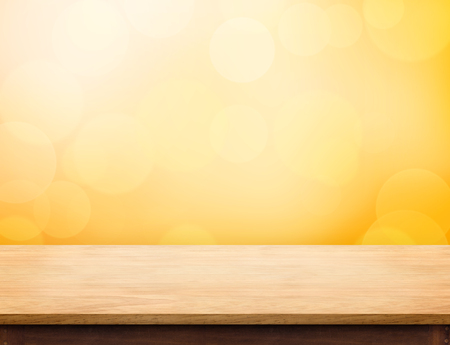 Empty wood table top (food stand) with abstract blur orange bokeh background,Autumn backgorund,Mock up for display or montage of product,banner for advertise on onlineの写真素材