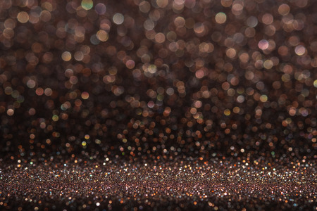 Abstract dark orange brown sparkling glitter wall and floor perspective background studio with blur bokeh.luxury holiday backdrop mock up for display of product.holiday festive greeting cardの写真素材
