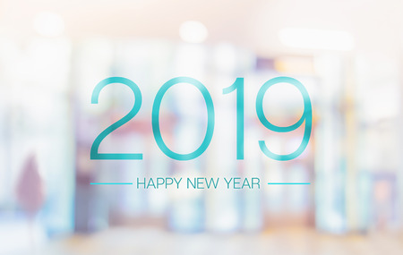 Happy new year 2019 word on blur pale color convention hall office building bokeh backgroundの写真素材