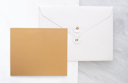 Top view of blank gold card overlap on white envelop on two layer step of marble table top.Mock up template for display of design .luxury business itemsの写真素材