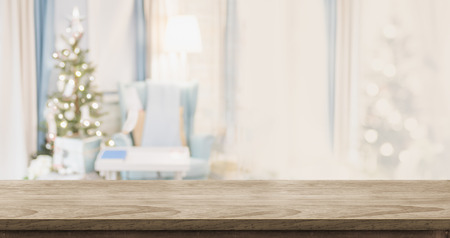 Empty wood table top with abstract warm living room decor with christmas tree blur background with bokeh light,Holiday backdrop,Mock up banner for display of advertise product ,luxury houseの写真素材