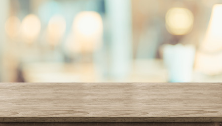 Empty rustic wood table and blurred soft light table in restaurant with bokeh background. product display template.Business presentationの写真素材