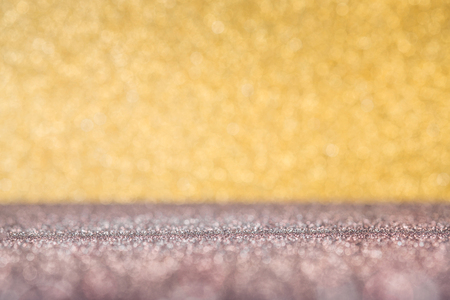 Abstract gold and pale red sparkling bokeh wall and floor background studio.luxury holiday backdrop mock up for display of product.holiday festive greeting cardの写真素材