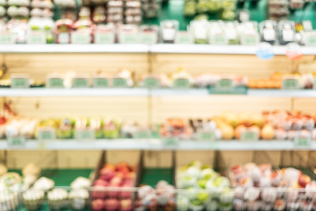 blur background of fresh food in supermarket shelf with bokeh light.grocery product on shelvesの写真素材