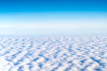 Blue sky and Cloud Top view from airplane window,Nature backgroundの写真素材