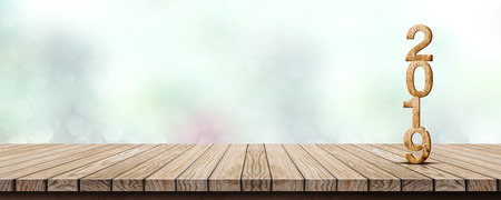 New year 2019 wood number (3d rendering) on wooden table at blur abstract green bokeh background,Mock up banner space for display or montage of product,holiday celebration greeting cardの写真素材