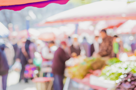Blurred background of people shopping at fresh market fair in sunny day.blur background with bokehの写真素材
