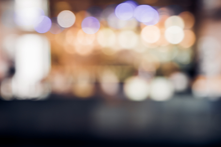 blur background of restuarant bar counter at night with bokeh lightの写真素材