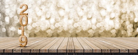 2019 happy new year wood number (3d rendering) on wood table with sparkling gold bokeh wall,leave space for display or montage of design or contentの写真素材