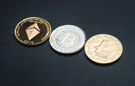 Cryptocurrency litecoin,Silver Bitcoin,Ethereum on black rough background,Digital cryto currencies.Virtual moneyの写真素材