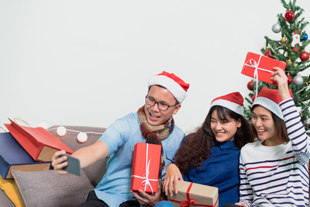 Christmas party with friends, asia woman selfie with smiling face with friends,Holiday celebration conceptの写真素材