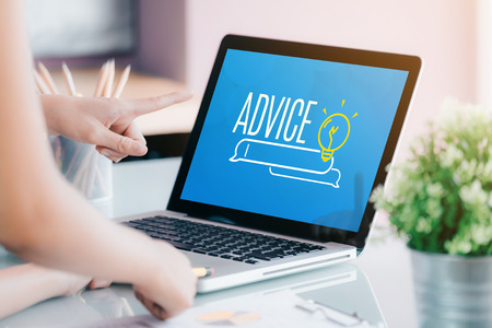 Close up businesswoman hand point at laptop screen with advice funciton on screen at office.business expert advice solution conceptの写真素材
