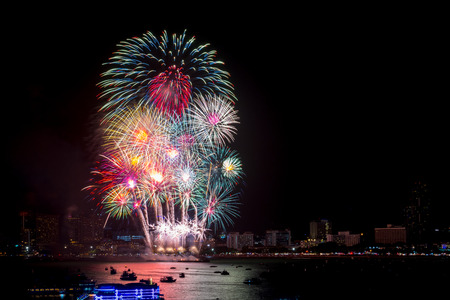 Fireworks explored over cityscape at night in sea port in Pattaya.Holiday festive celebration backgroundの写真素材